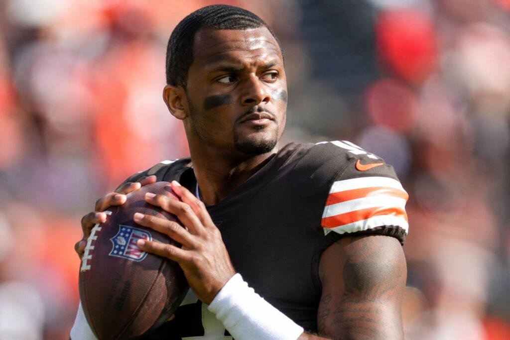 Deshaun Watson holding a football in a Cleveland Browns jersey during a game