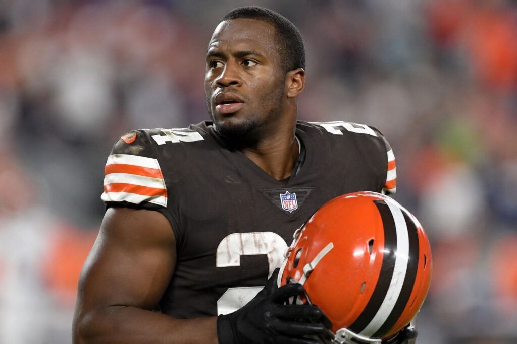Nick Chubb Retires: Career Stats, Injury Comebacks, and NFL Legacy Nick Chubb wearing a Cleveland Browns football uniform and holding his helmet on the sideline during an NFL game.